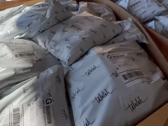 Packed orders in bins, ready for carrier pickup